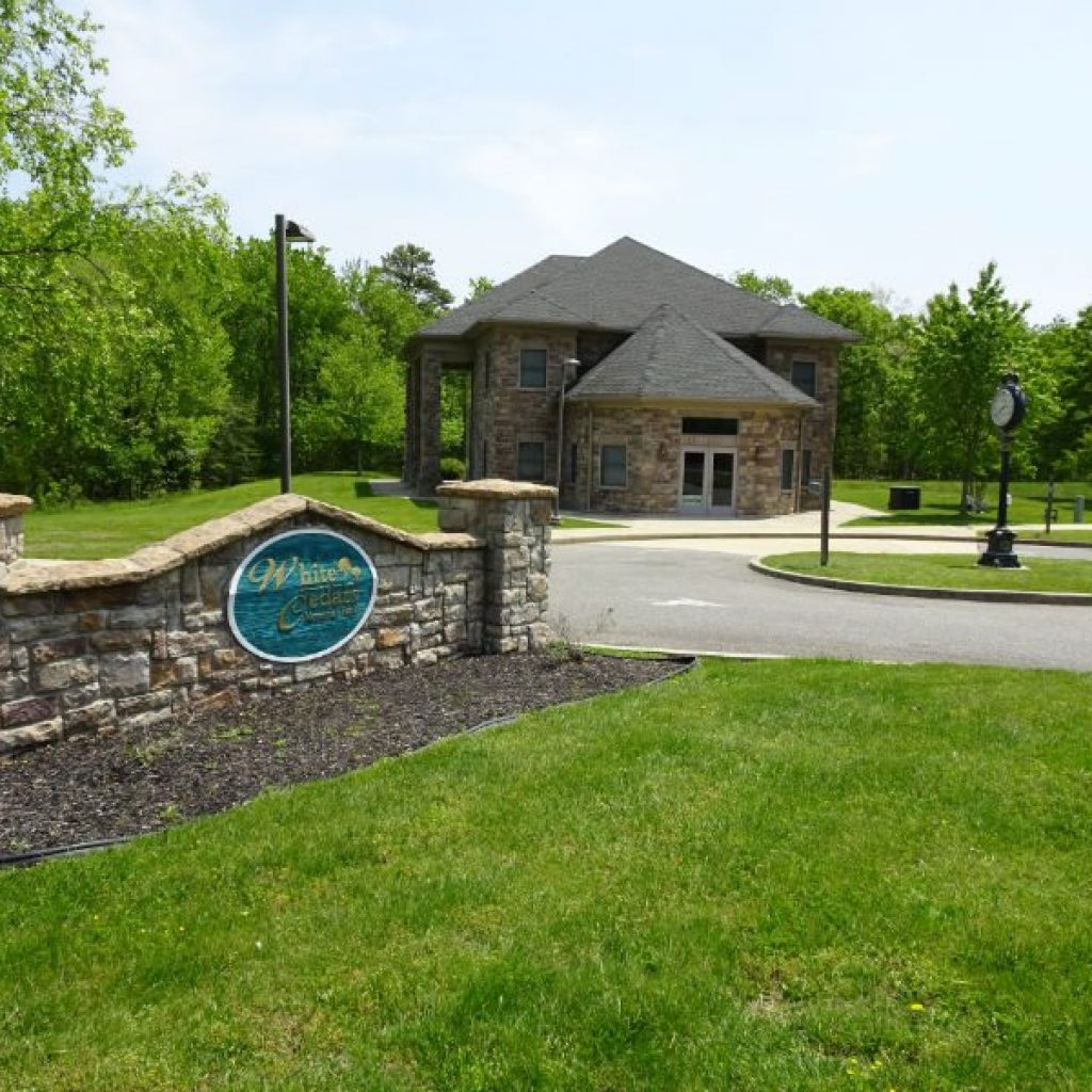 White Cedar sign and building in the background