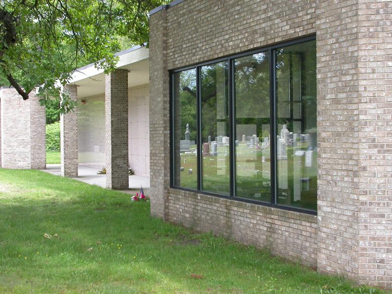 headstones in the window reflection