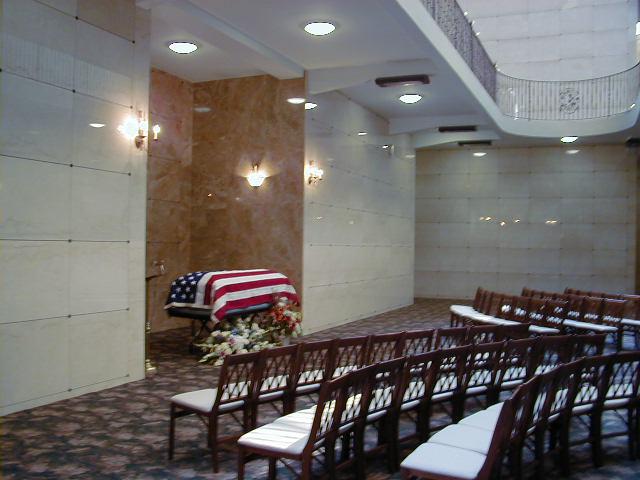american flag drapped over the casket in a mausoleum