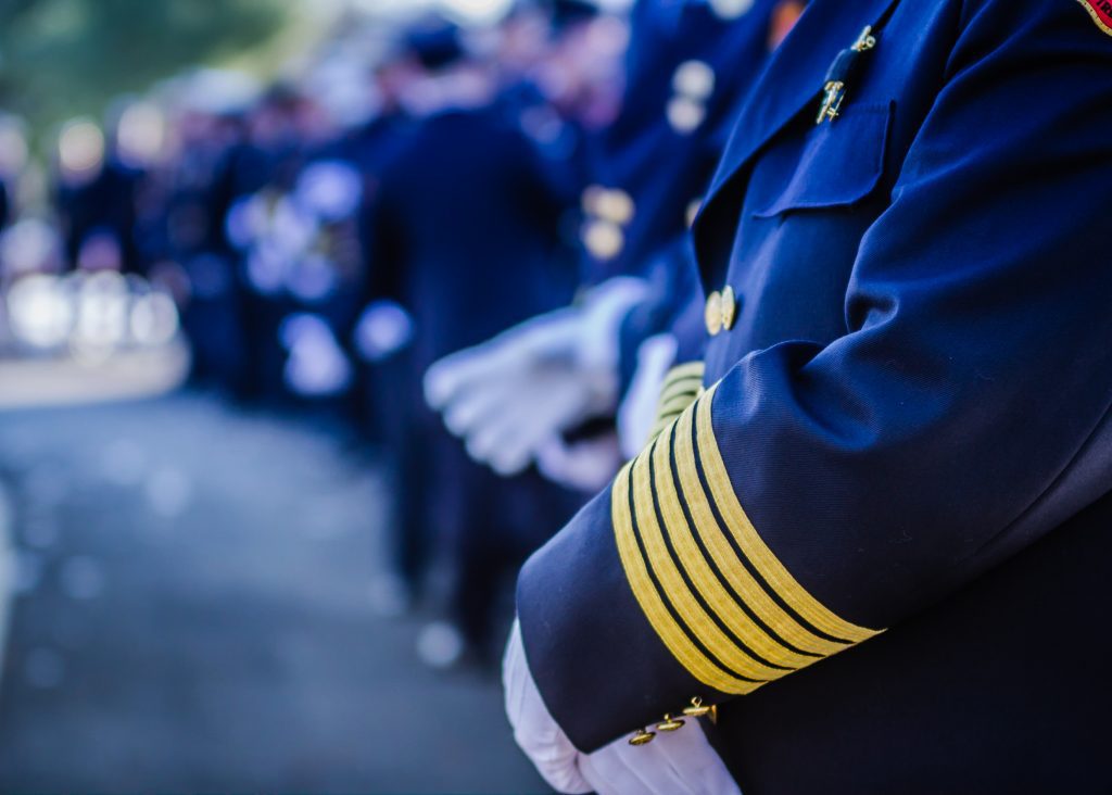 Men in uniforms at funeral service