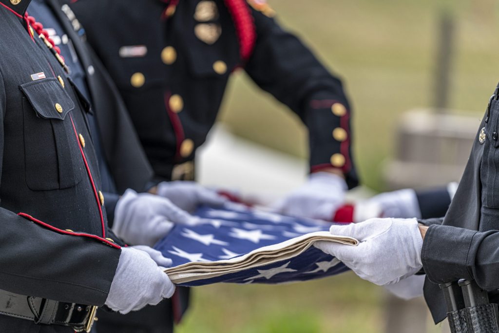 Six Person flag fold of an American Flag at a funeral for a fallen hero