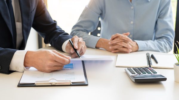 two people pre-planning arrangements with notebooks and calculator