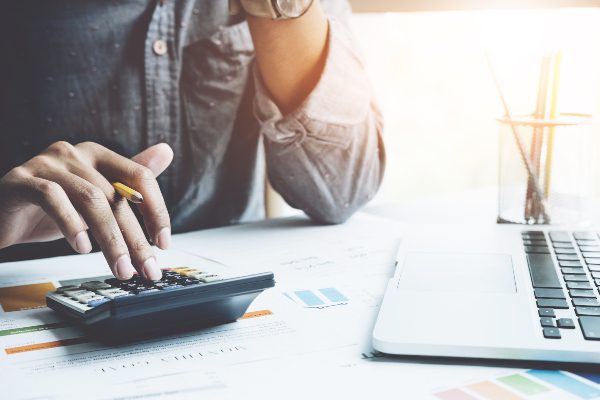 man planning finances with laptop and calculator