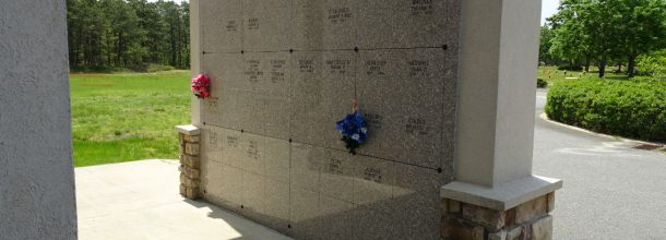 above ground burial with flowers on the stone