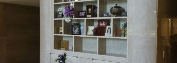 shelves in a mausoleum with flowers and ribbons from visitors shelves in a mausoleum with flowers and ribbons from visitors